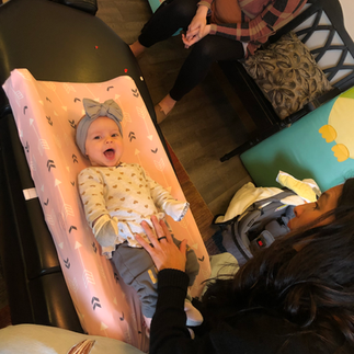 Chiropractor adjusting infant