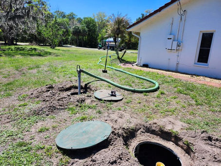 Septic technician inspecting an open residential septic tank during a septic system inspection in Port Charlotte