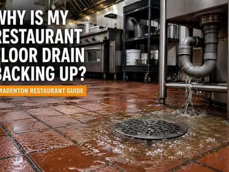 Commercial kitchen floor drain backing up during service in a Bradenton restaurant, showing standing wastewater and drainage problems caused by grease trap buildup.
