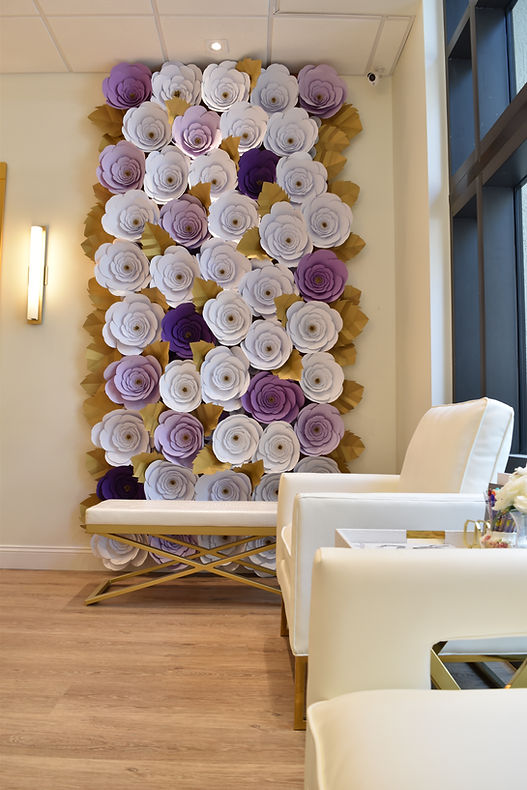 Purple and white flower wall at Blow To Paris hair salon
