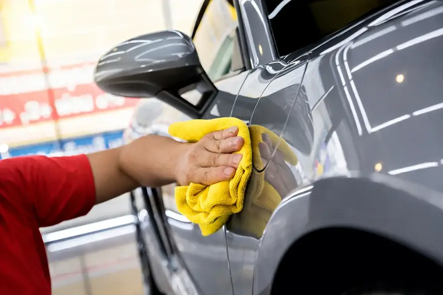 Like New Car Detailing team doing hand wiping on the car exterior