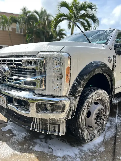 Front exterior detailing wash on a white Ford truck at our Pearl City shop.
