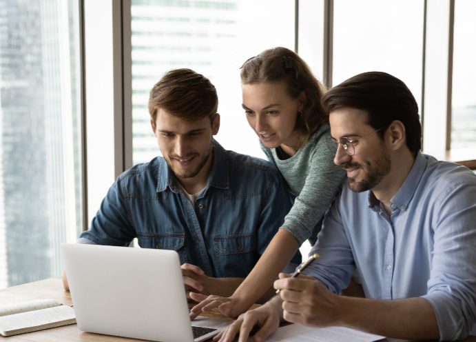 Creative business team sharing laptop in office, watching startup presentation, design pro