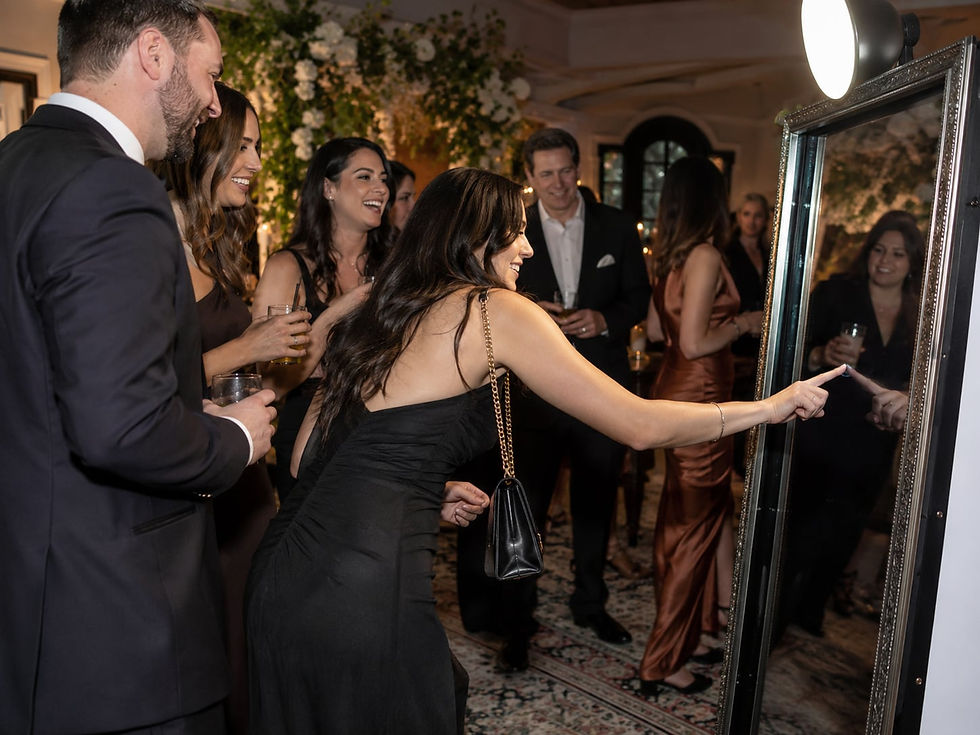 Coworkers enjoying an Interactive Mirror Photo Booth at a company event.