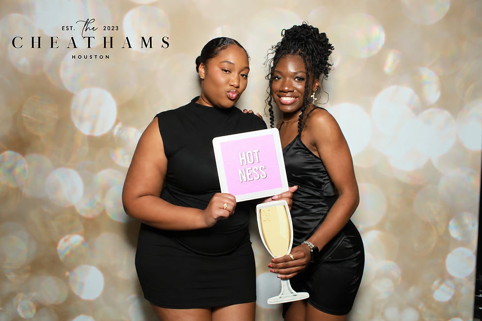 Two guests holding a Photo Booth print during an event.