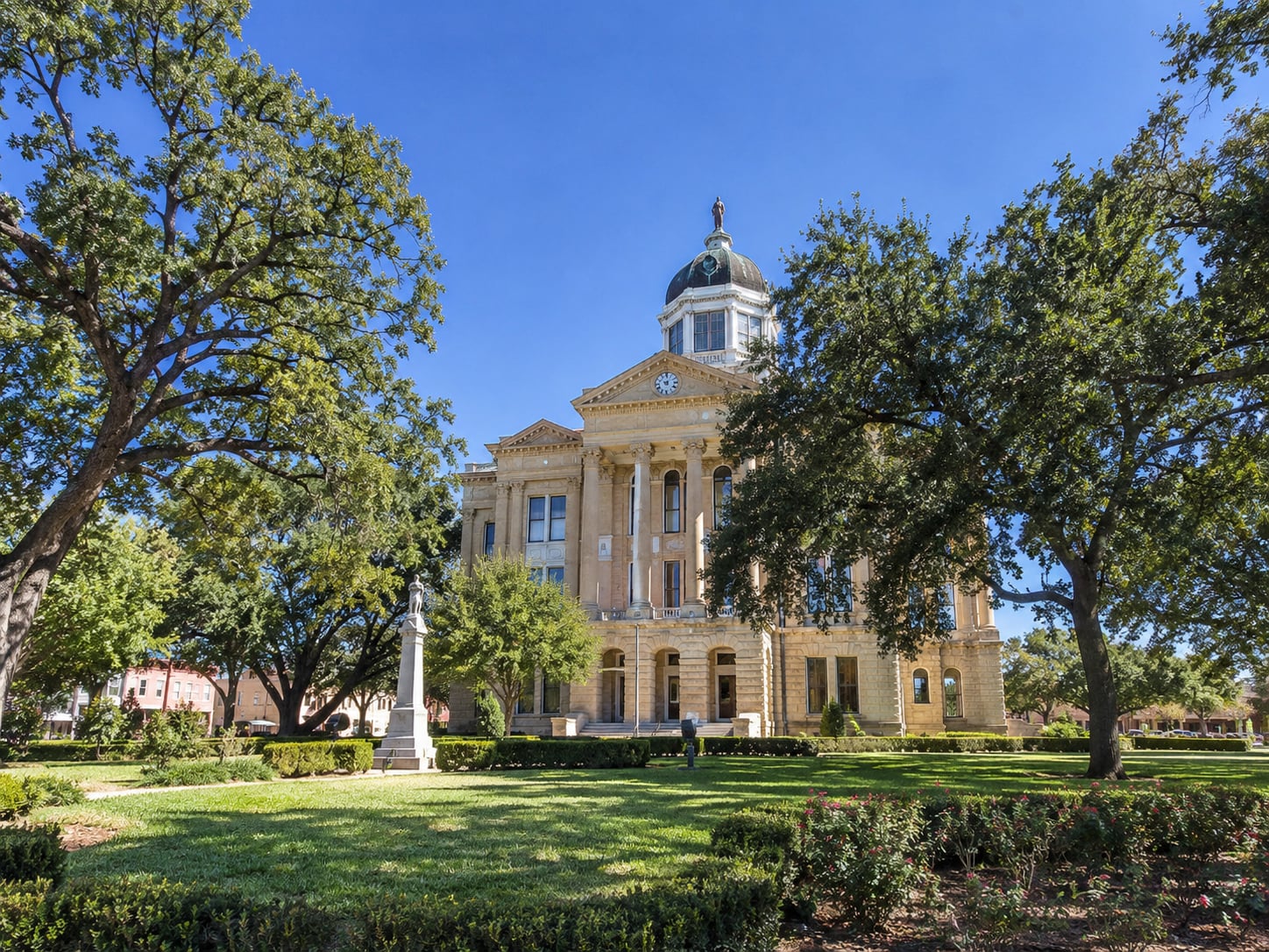 Historic courthouse surrounded by mature trees in Richmond, Texas.
