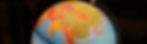 Close-up of a lit globe showing Asia and Europe with detailed map colors. The globe sits against a dark background, creating a warm vibe.