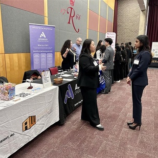 Advanced Creative Media employees conversing with students at the Rutgers Business School career fair.