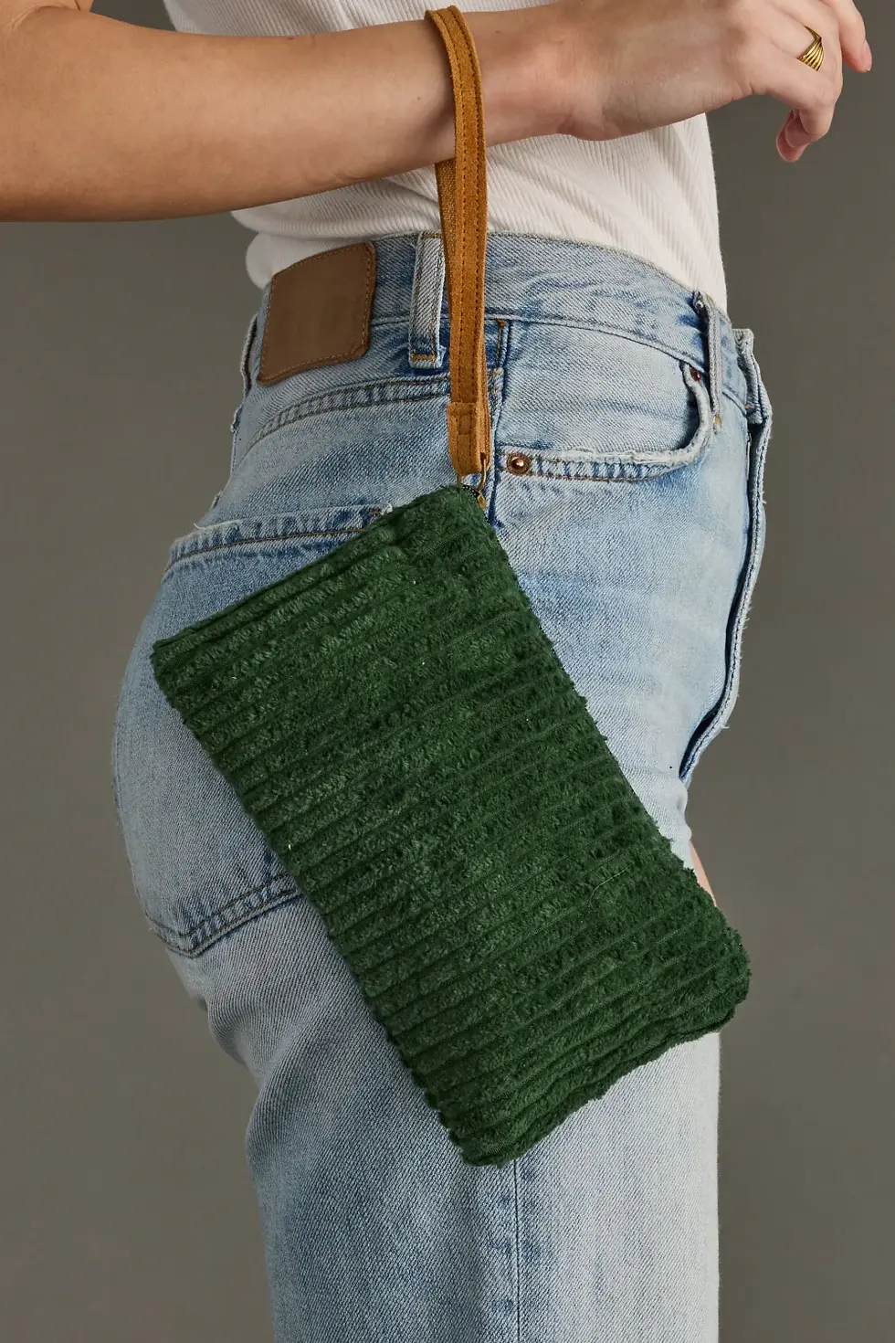 Dark Green Corduroy Wristlet being worn with blue jeans.