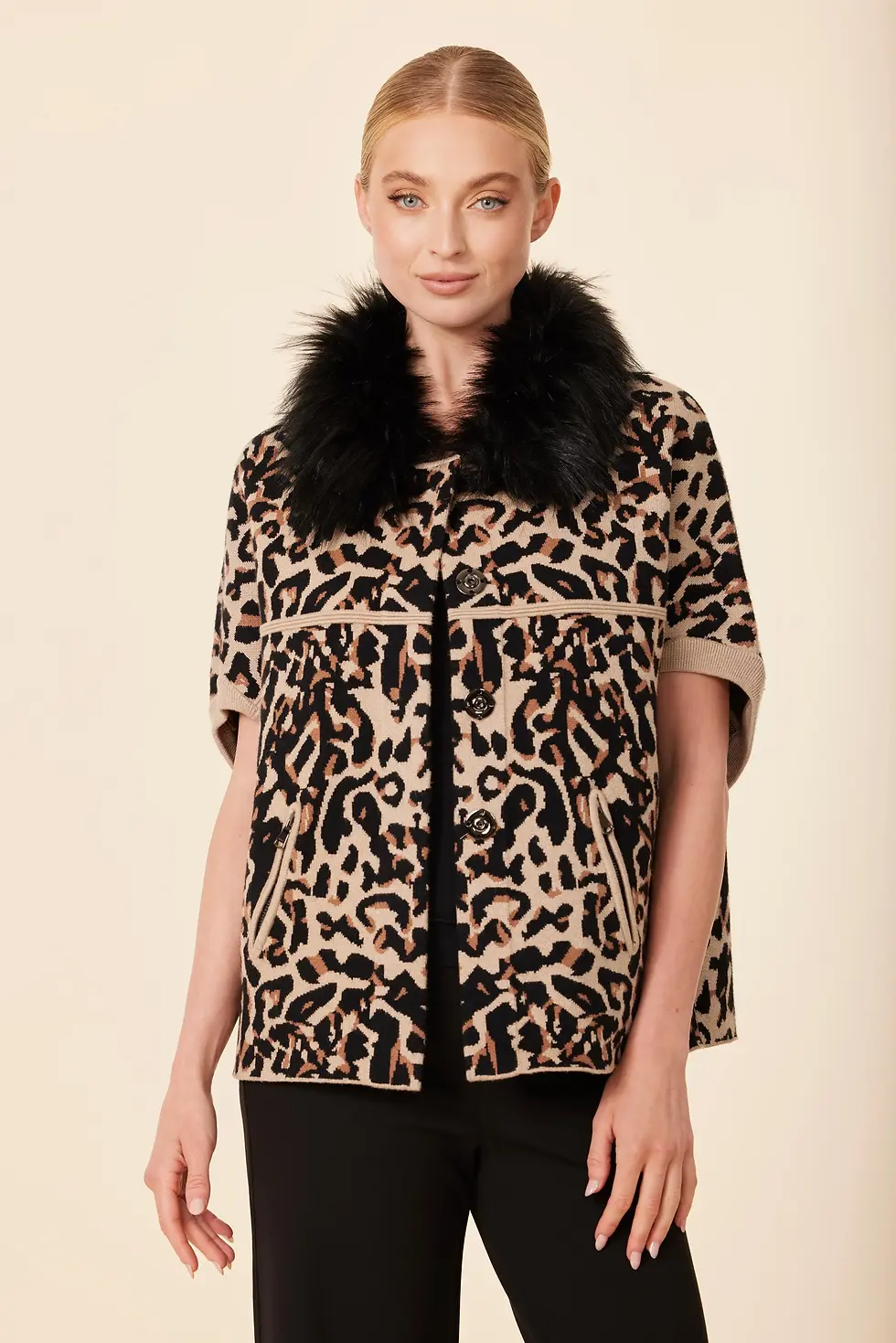 Thumbnail: Front view of a model wearing a black short-sleeve cardigan with a faux-fur leopard collar, showing bare arms.