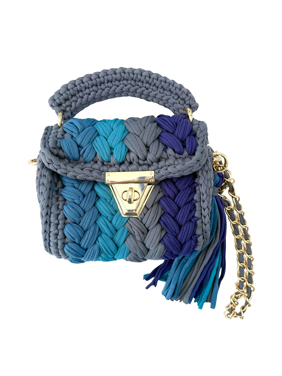 Front view of a puffy woven bag in dark blue, bright blue, gray, and navy with a removable vegan leather and chain crossbody