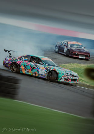 two drifting japanese cars on a race track