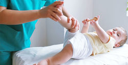 Physiotherapist-massaging-little-baby-boy-foot-1-2000