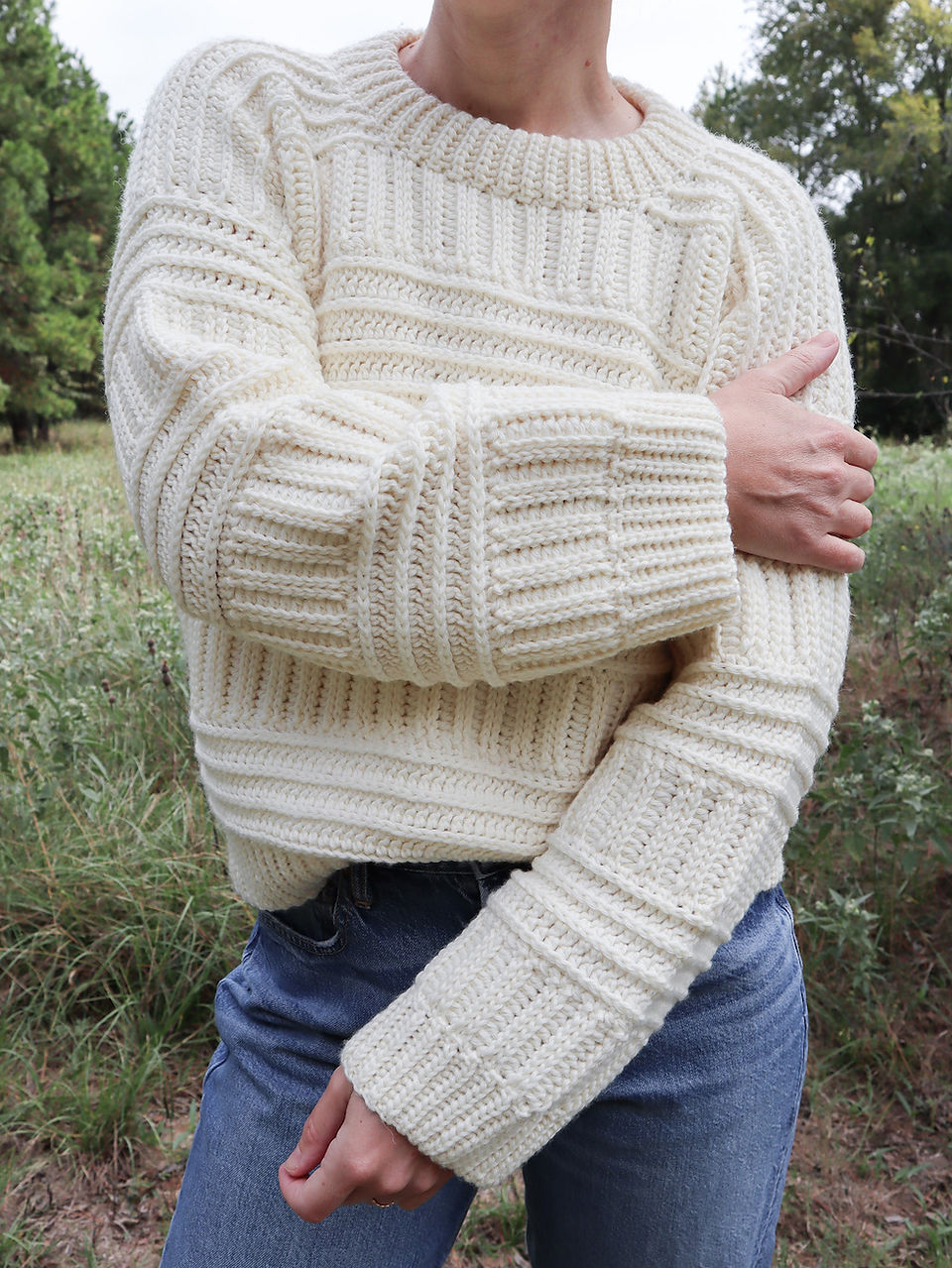 girl modeling handmade crochet sweater in ivory featuring knit-like textures