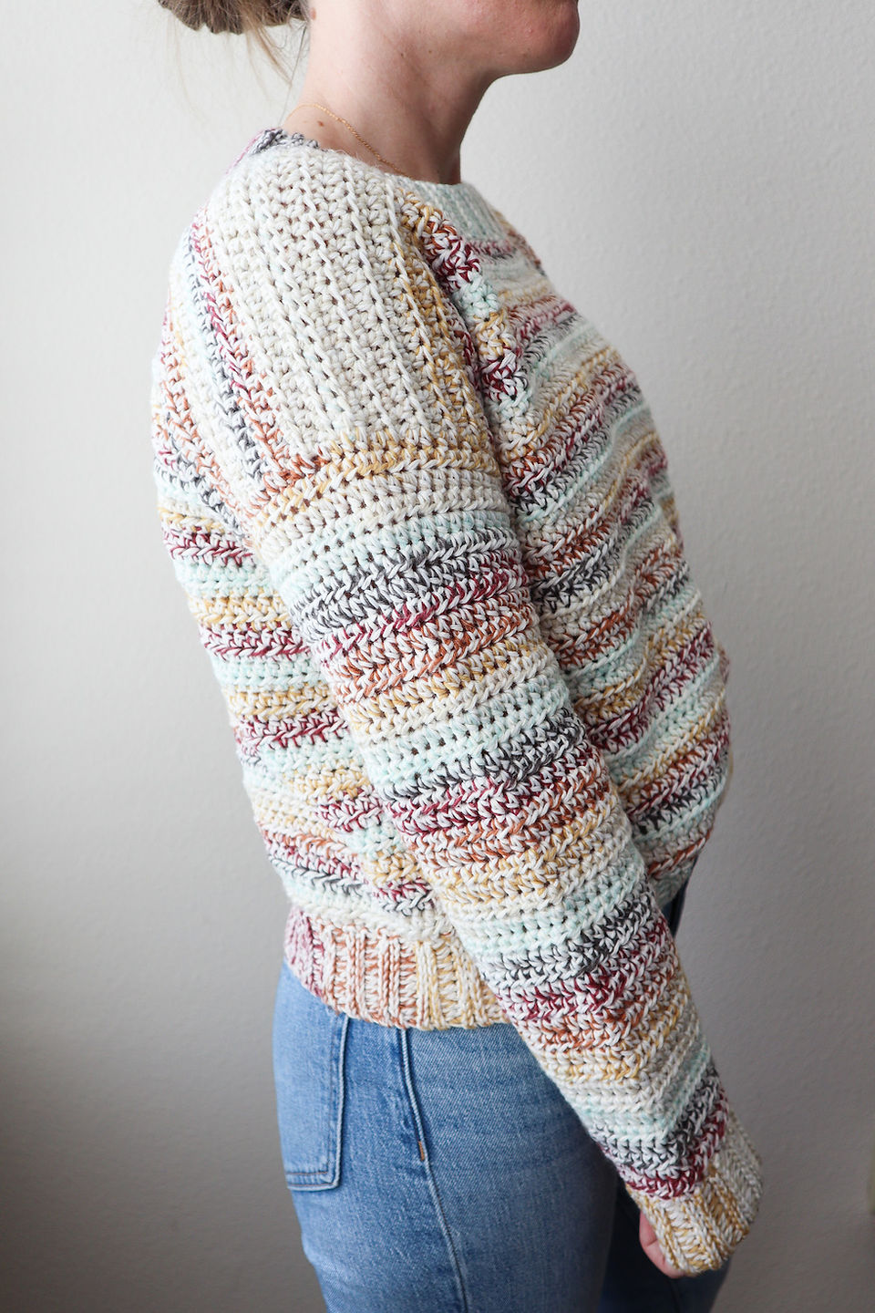girl modeling a handmade crochet striped sweater