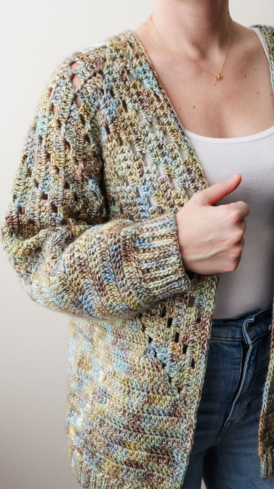 girl modeling handmade crochet hexagon sweater cardigan in variegated yarn