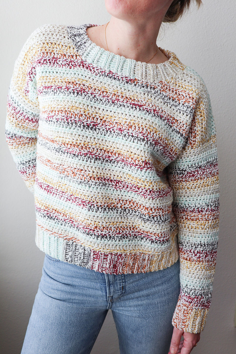 girl modeling a handmade crochet striped sweater