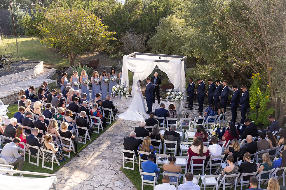 Eye-level view of rustic wedding pavilion surrounded by oak trees
