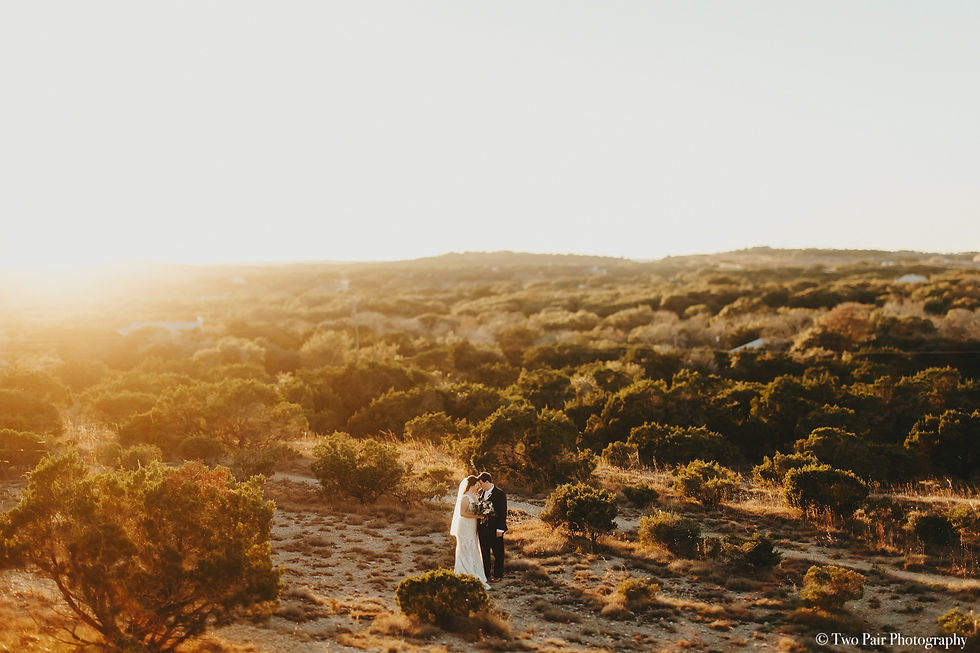 Eye-level view of elegant outdoor wedding setup with white chairs and floral decorations