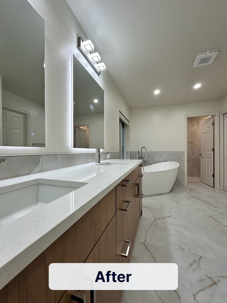 Premium bathroom transformation featuring a handcrafted vanity, LED mirrors, freestanding tub, and large porcelain floor tiles.