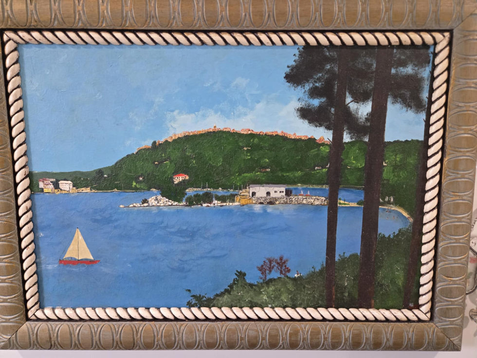 Framed painting: sailboat on calm water near a hillside