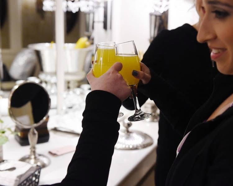 Two women toasting mimosas, Wedding Moments, bridal suite prep