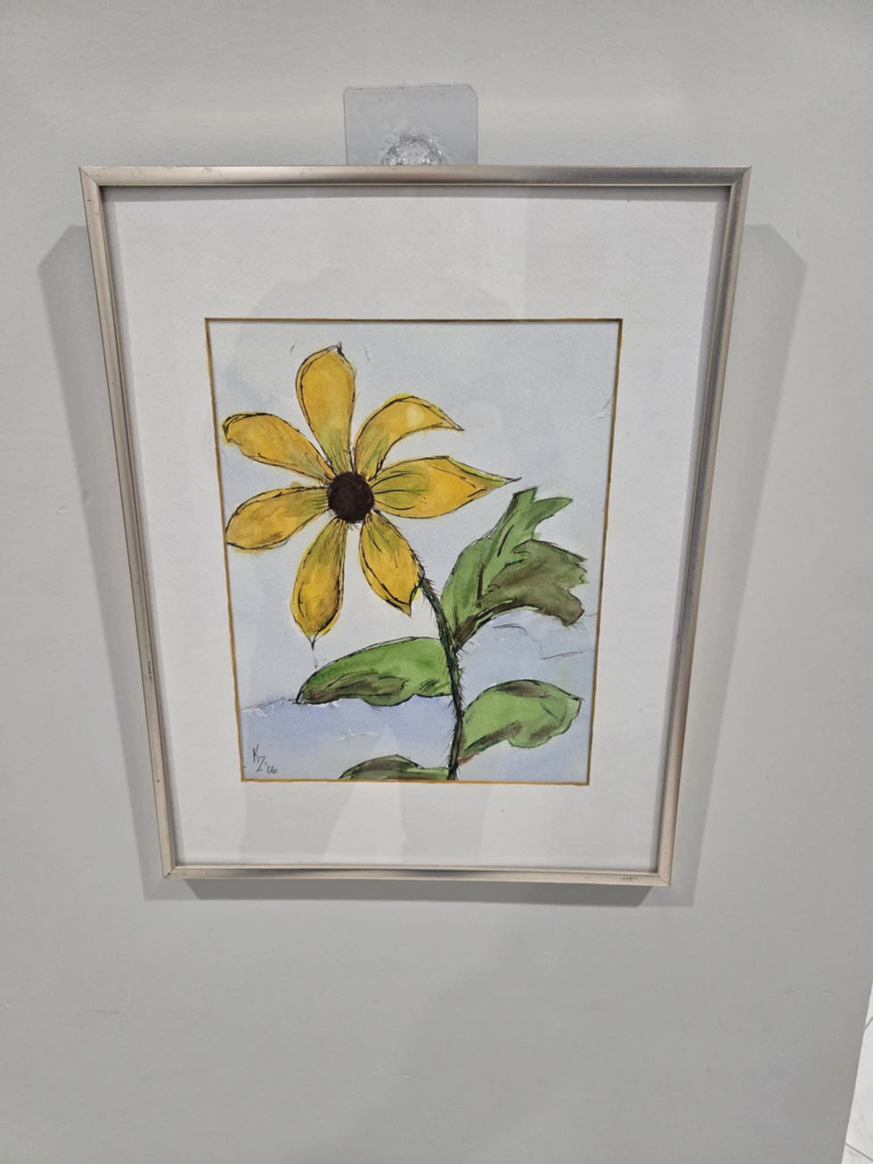 Framed watercolor painting of a yellow flower