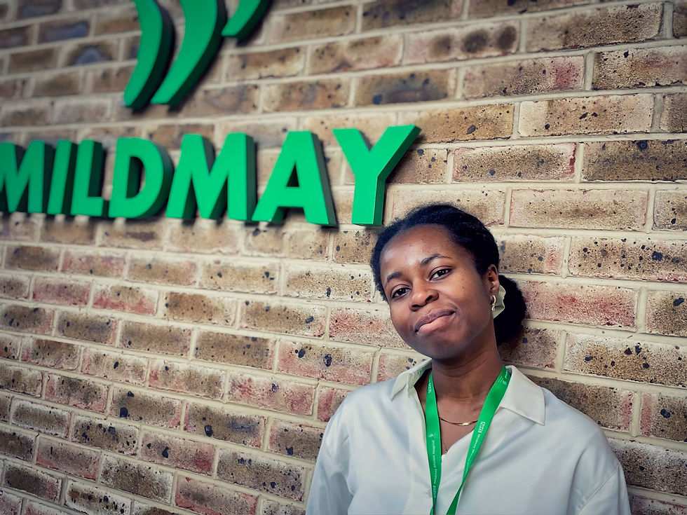 Dietetics student Tioluwa by the Mildmay entrance sign
