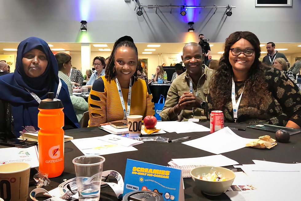 Marion, Meshonett, Rhoda and Clive share a table at the IDDSI Congress in September 2023