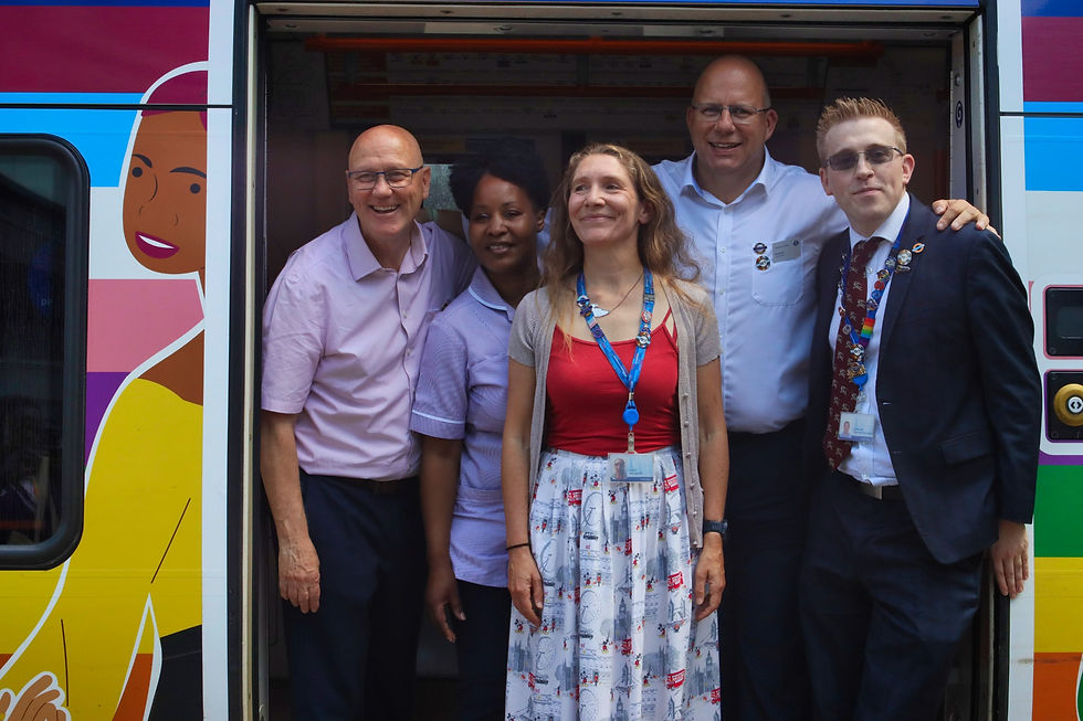 Key stakeholders pose in the open door of the Pride Train