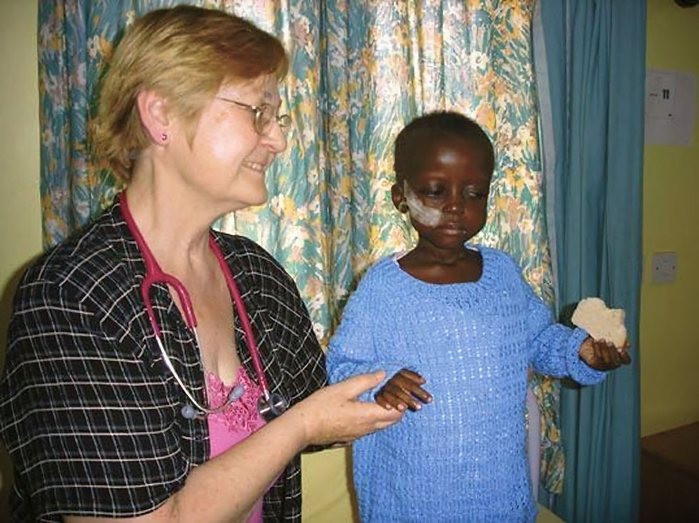 Dr Moss with a young boy called Solomon, in the Mildmay Paediatric Care Centre, Uganda.