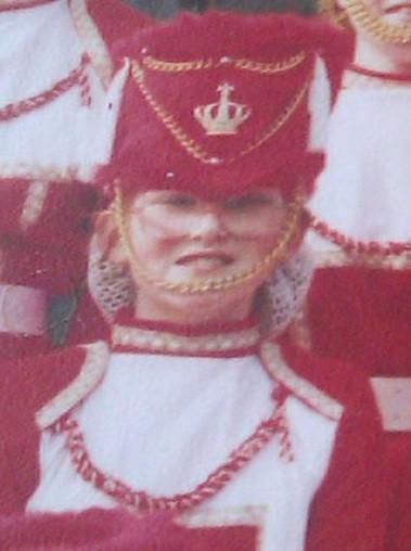 Same girl but younger in a red uniform.