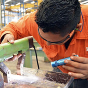 Worker adjusting quality control settings in the workshop