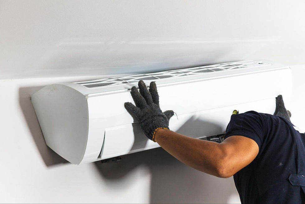 An HVAC technician installs a ductless mini split unit during an air conditioning replacement.