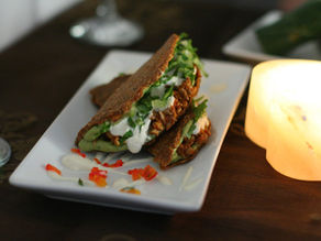Raw Vegan Tacos on a plate with a candle next to it