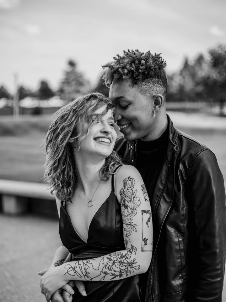 black and white LGBT couple smiling and embracing Colorado St. Louis urban couples session