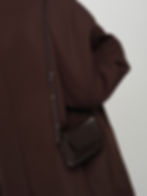 PALOMA leather cross body bag and clutch in chocolate brown on model for size and scale