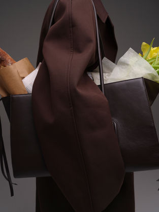 A quality black leather tote bag with long shoulder straps by SIÉ STUDIO.