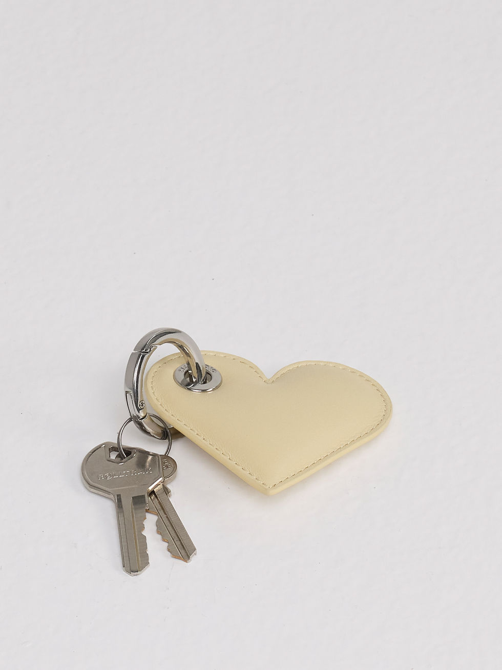 LOLITA heart-shaped leather key ring in soft butter cream with keys for scale