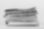 a large stack of newspapers on the table is a black and white photo.jpg
