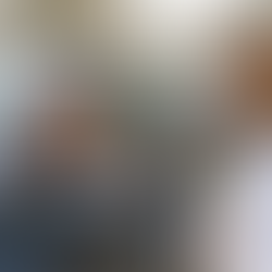 Doctor assisting an injured driver at the scene of a car accident, with the driver holding his head in pain and two damaged vehicles in the background.