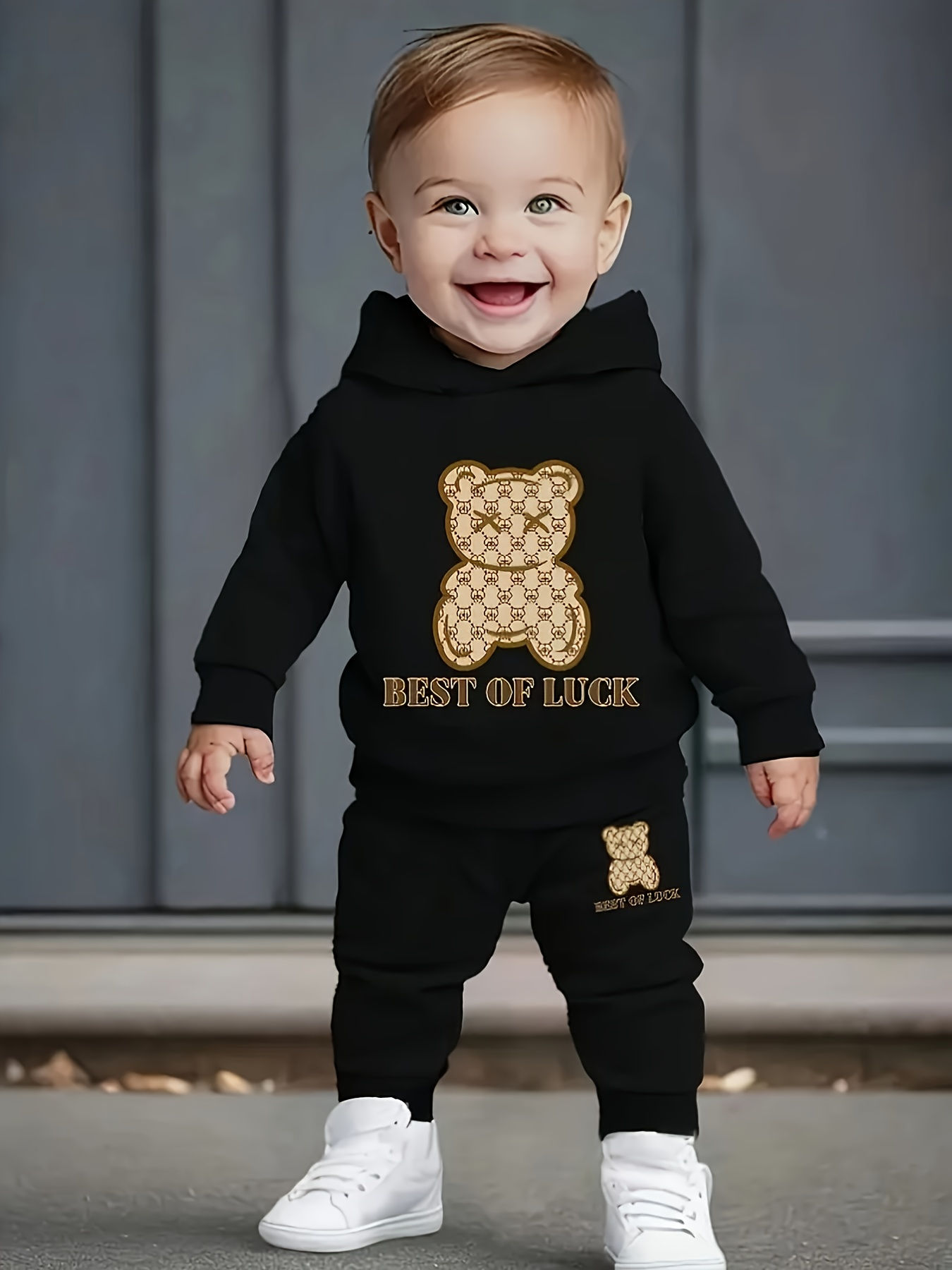 A two-piece cartoon printed fleece hoodie and long pants set for a newborn baby