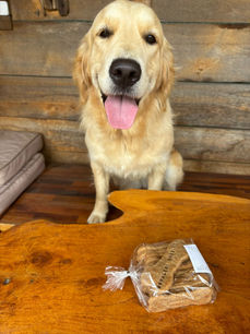 Golden retriever dog smiles near Bark 'n Bake product. L&V's Bark 'n Bake