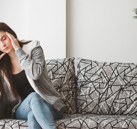 young-woman-sitting-sofa-home.jpg