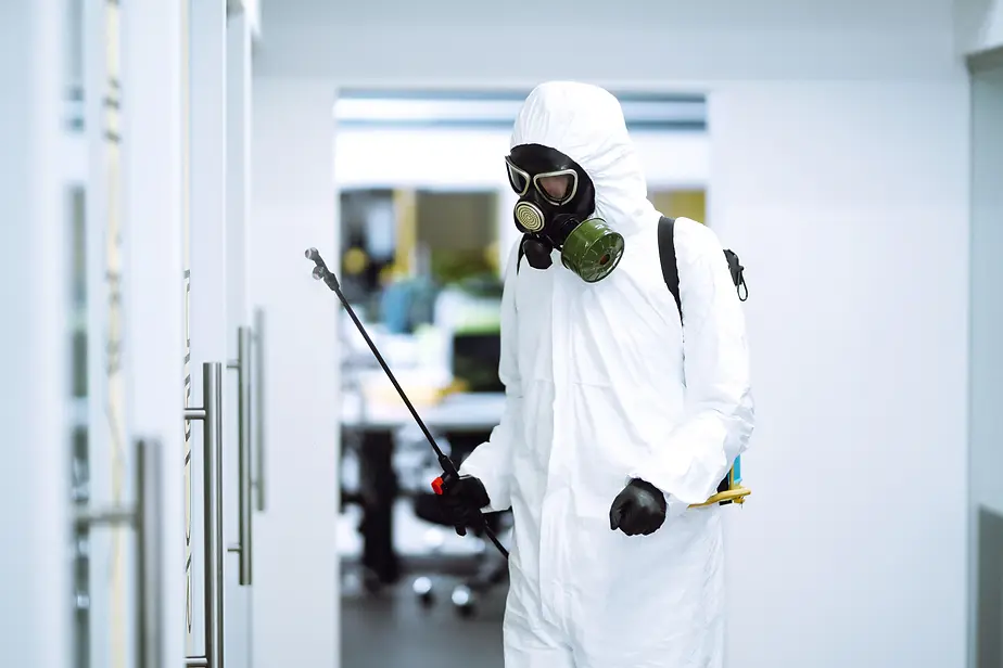 squash_man-in-hazmat-suit-disinfecting-an-office-2026-03-23-23-33-03-utc.webp