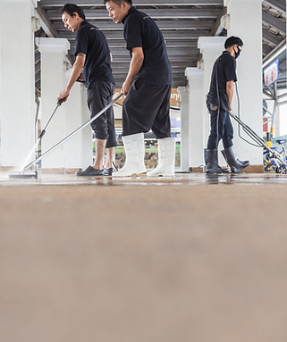 Asian worker cleaning sand wash exterior walkway