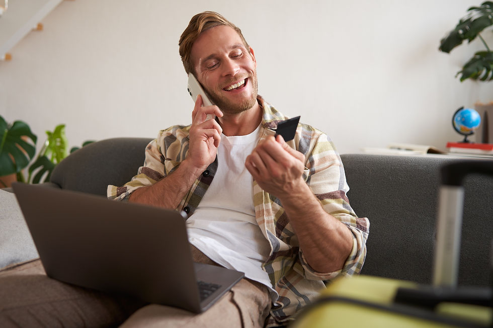 portrait-happy-tourist-young-man-with-laptop-credit-card-talking-mobile-phone-calling.jpg