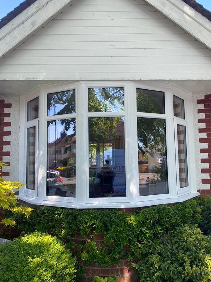 Bay window installation on house exterior