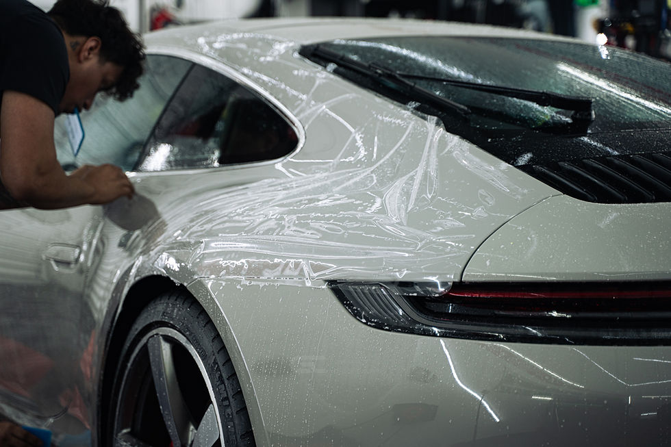 Technician installing paint protection film on a Porsche 911 rear quarter in Miami
