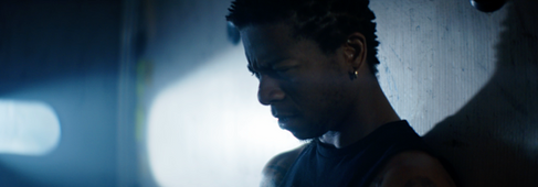 Close-up of a man in the Loud short film looking down.
